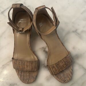 Johnston & Murphy heels cork with a gray and metallic color .